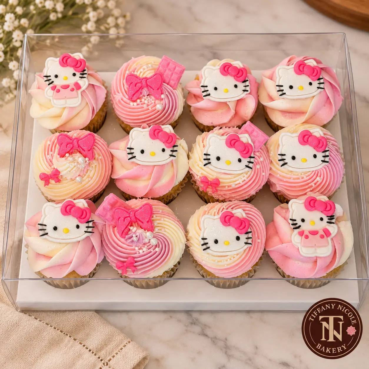 Hello Kitty cupcakes with pink and cream buttercream in a clear bakery box