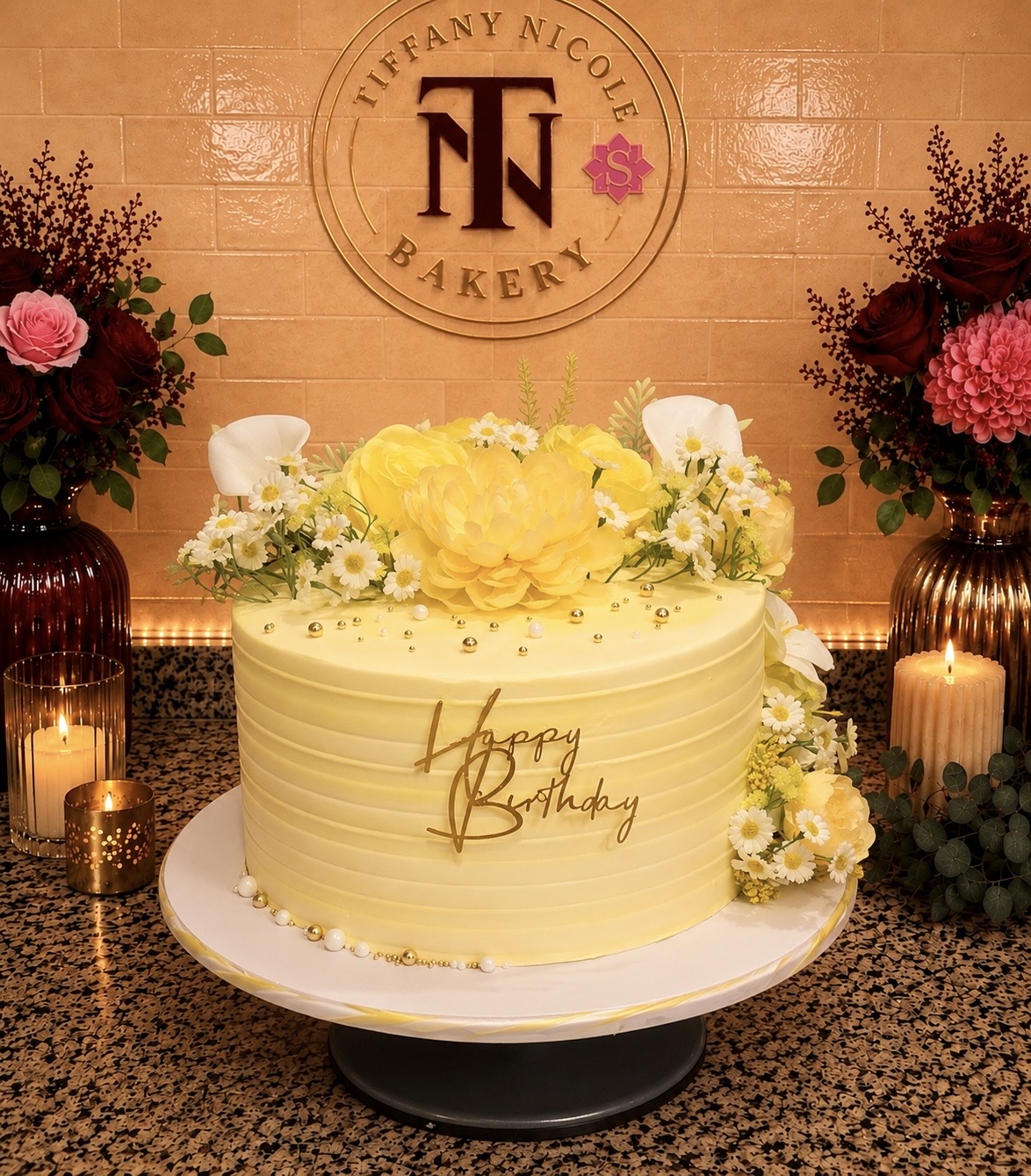 Yellow floral birthday cake with daisies and gold lettering